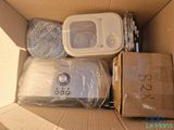 a cardboard box with a microwave and other items in it
