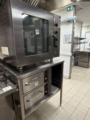 a large commercial kitchen with stainless steel appliances in it