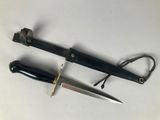 two knives that are laying next to each other on a table