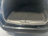 the back of a car with its trunk open in a showroom