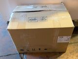 a box that is sitting on the floor next to a refrigerator
