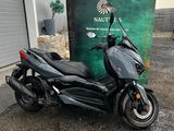 a black motorcycle parked in front of a building