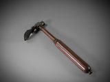 an old hammer with a wooden handle on a gray surface