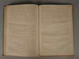 an open book on a table with writing on it