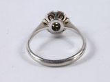 an image of a silver ring with a black stone in the center