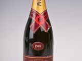 a close up of a bottle of champagne on a white surface