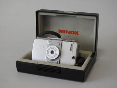 a small camera in a case on a table