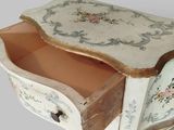 a small table with a drawer on top of it