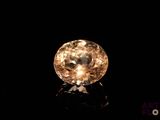 a close up of a yellow diamond on a black surface