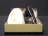 a black bag and a white bag in a gold box