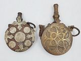 pair of antique brass flasks with decorative designs on them