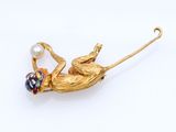 an image of a gold frog broochle with a pearl bead