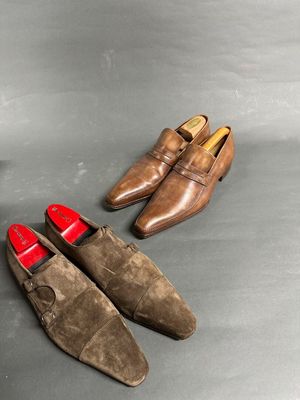 two pairs of brown shoes sitting next to each other on a table