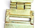 a close up of a gold belt buckle on a white surface