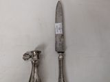 a knife and a spoon sitting on a table