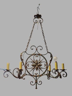 an image of a chandelier with five lit candles hanging from it