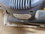 a close up of a corded sander on a table
