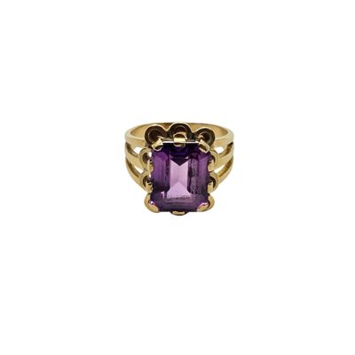 a gold ring with an amethorate stone in the center