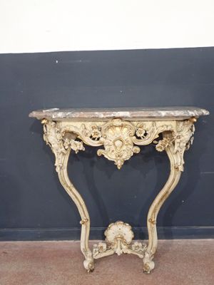 a small table with a marble top on the floor