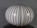 a white ball with brown stripes on it on a table