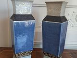 two vases that are sitting on a table