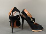 pair of black sued high heeled shoes with gold buckles