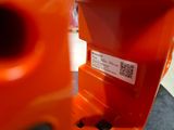 a close up of an orange parking meter with a qr code on it