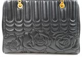 a close up of a black purse with roses on it