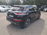 the rear end of a black suv parked in a parking lot