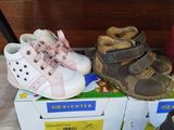 several pairs of baby shoes are sitting on top of a box