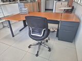 a desk with a chair and a computer on it