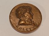 a close up of a coin on a white surface