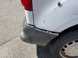 a close up of a white truck with rust on the side of it