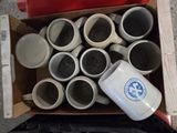 a box full of coffee cups sitting on the ground