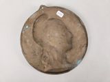 an old metal plate with a picture of a man ' s head on it