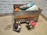 a wooden box filled with assorted items in front of a wall
