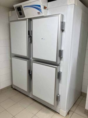 an image of a refrigerator in a bathroom with tile flooring