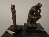 two statues of a man and a dog on display