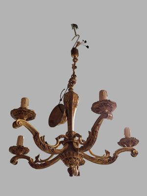a chandelier that has a bird on top of it