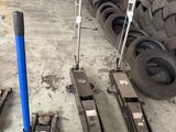 a pile of tires and a blue pole in a warehouse