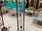 a floor lamp that is sitting on a tile floor