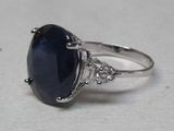 an image of a ring with a large blue stone