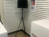 a television on a tripod in the corner of a room