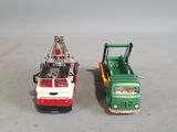 two toy trucks that are sitting next to each other