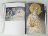 an open book with a picture of jesus on it