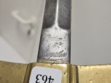 a person holding a knife with a price tag on it