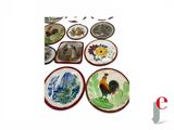 many plates with different designs on them on a table