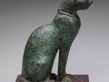 statue of a cat sitting on a stone base