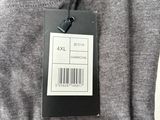 the back of a gray sweatshirt with a barcode on it