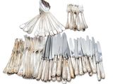 a lot of forks and spoons that are sitting on a table